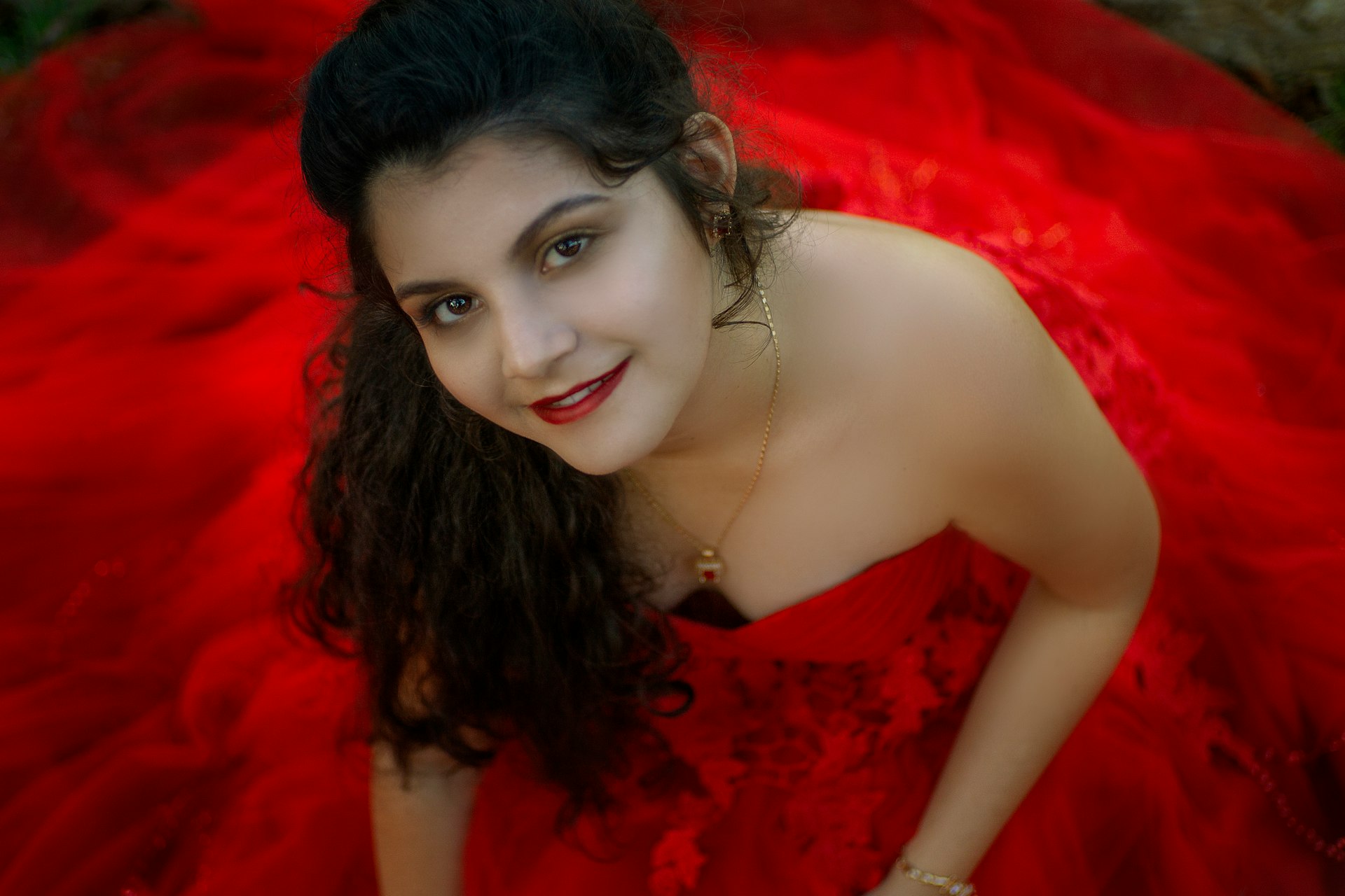 a woman in a red dress posing for a picture